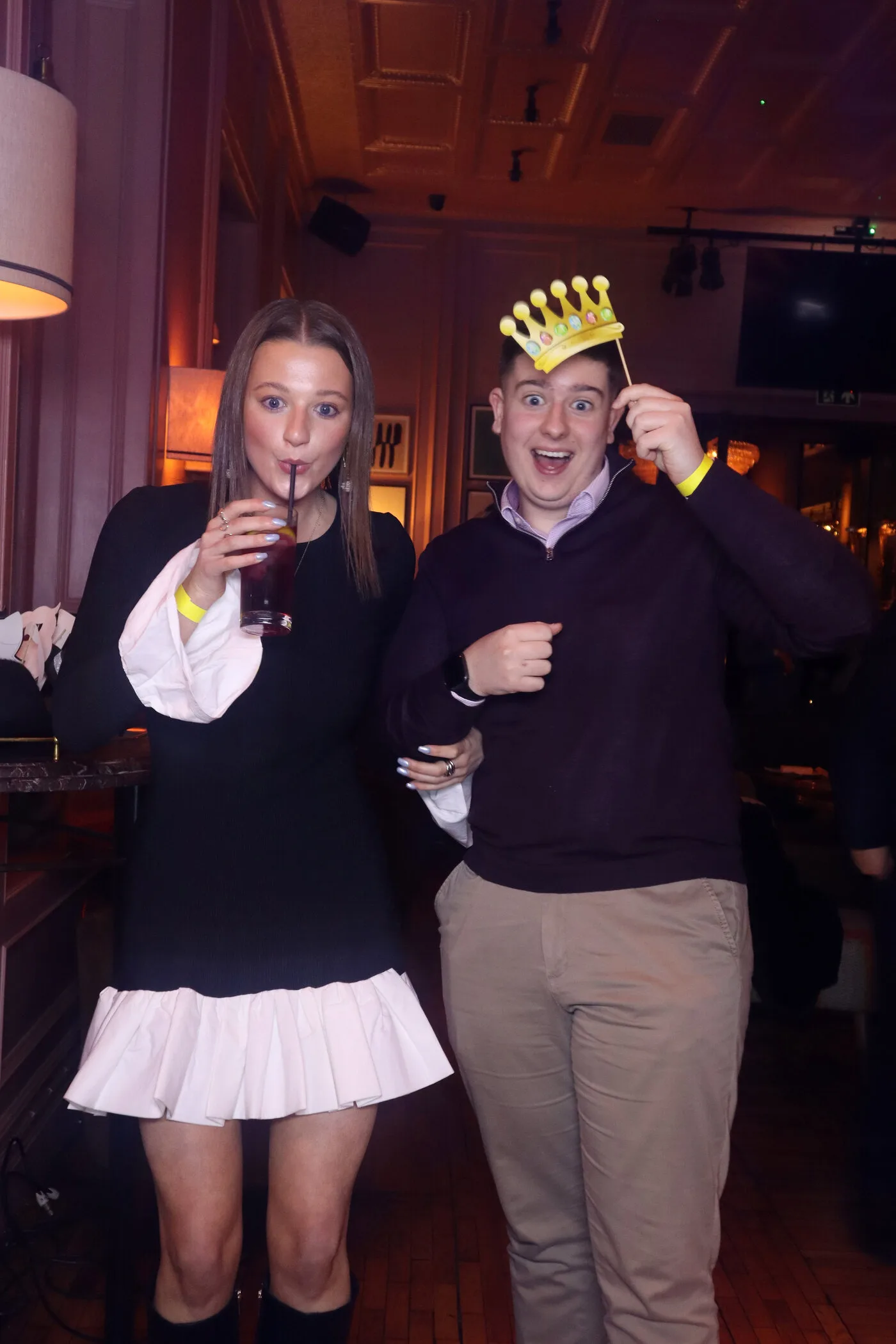 Group of friends posing with fun photo booth props at a party in Ireland