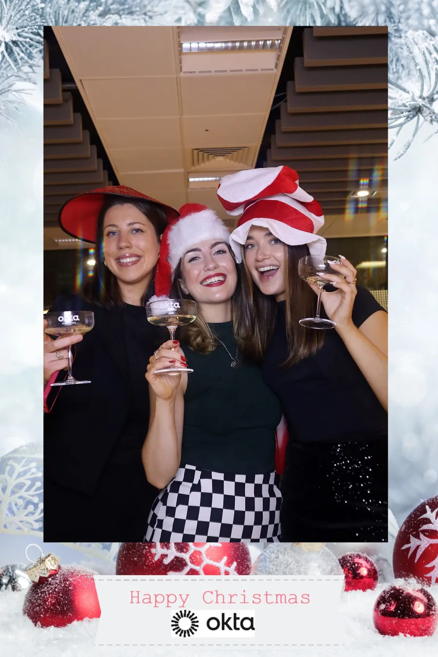 Portrait Christmas photo booth print template with guests in Santa hats, a snowy border and a Happy Christmas branded footer