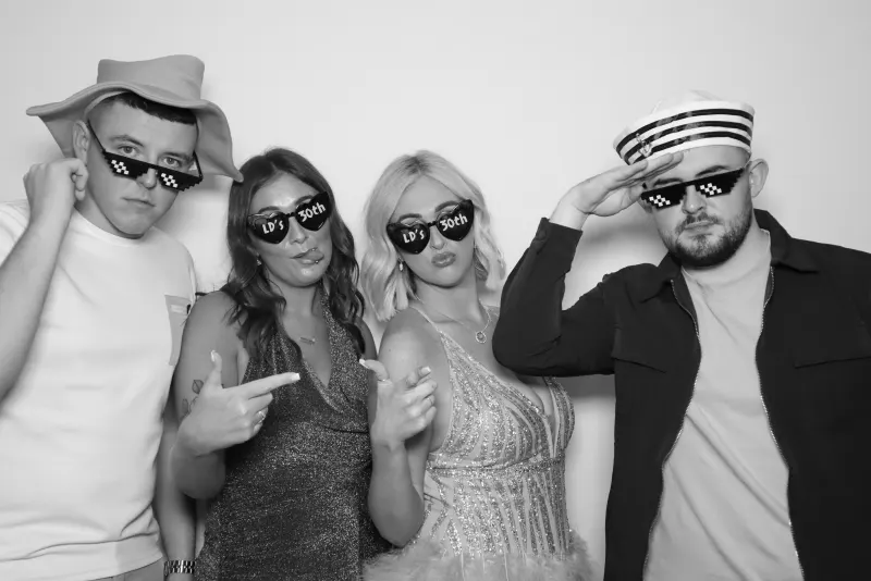 Birthday party photo booth black and white group with props and sunglasses