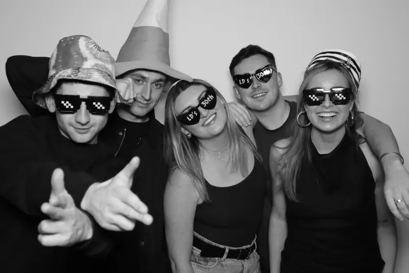 Party group with props and sunglasses in black and white
