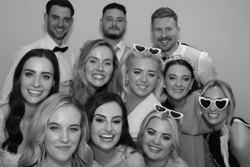 Wedding bridal party group photo in black and white at photo booth