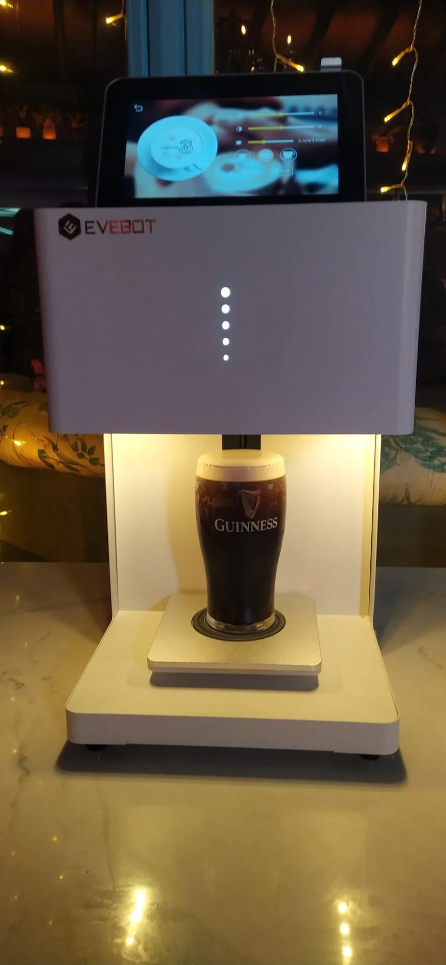 The drinks printer printing a design onto a freshly poured pint of Guinness at a bar