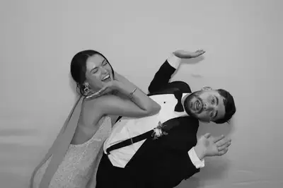 Couple having fun in the glam photo booth